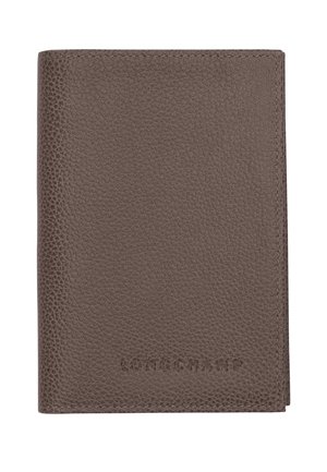 Brown textured leather wallet with "LONGCHAMP" embossed on the lower front center, shown closed against a white background.