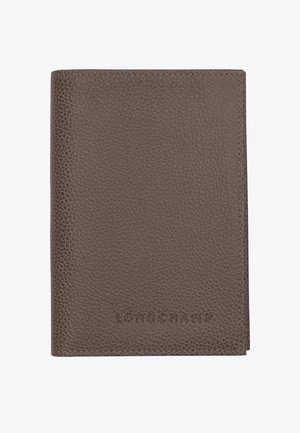 Brown textured leather wallet with "LONGCHAMP" embossed on the lower front center, shown closed against a white background.