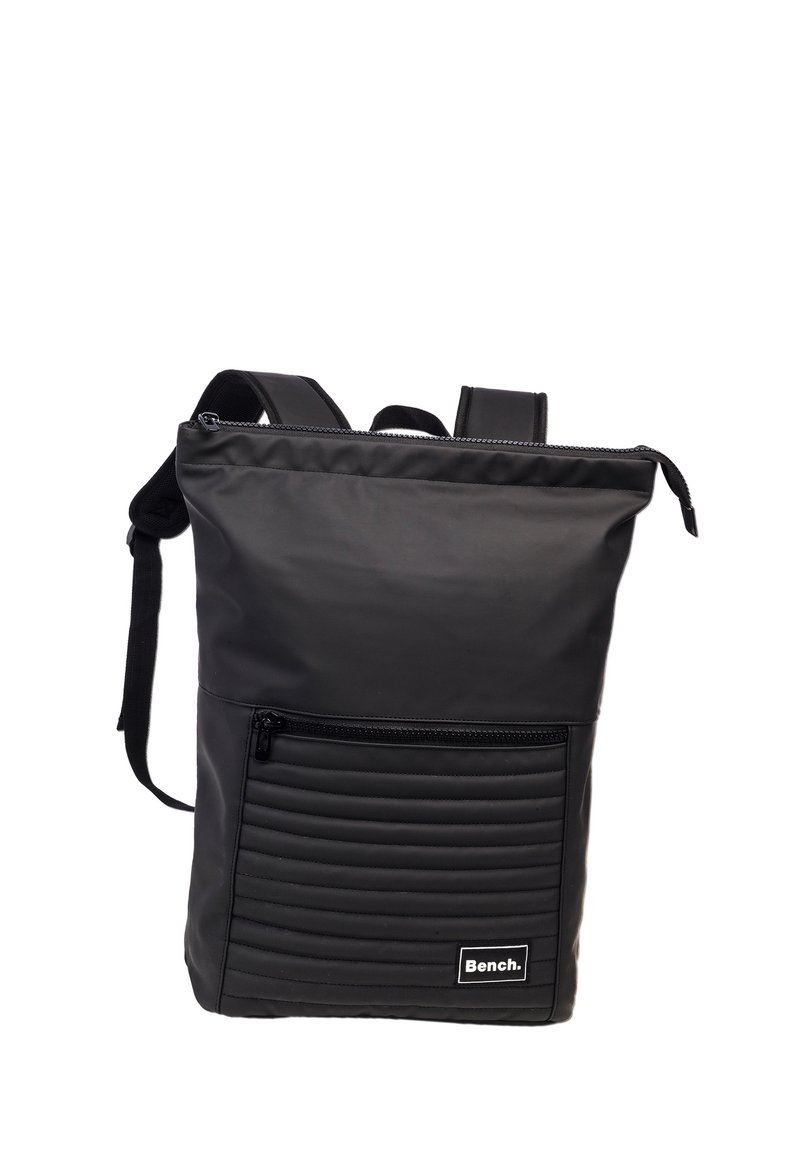 Black nylon backpack with a smooth finish, featuring a zippered front pocket with horizontal ribbed texture and adjustable shoulder straps.