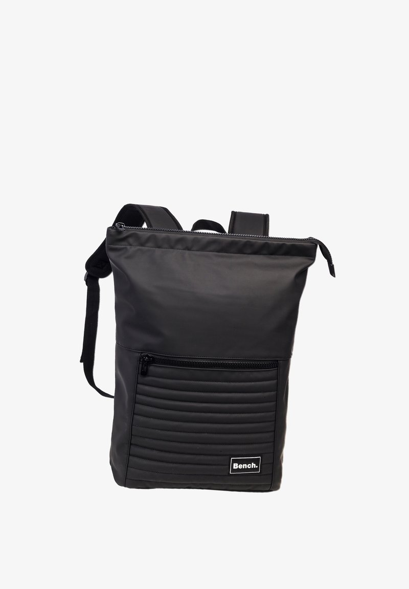 Black nylon backpack with a smooth finish, featuring a zippered front pocket with horizontal ribbed texture and adjustable shoulder straps.