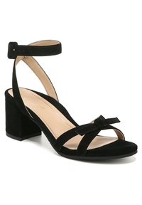 Black suede heeled sandals feature an ankle strap, block heel, open toe, and a bow detail on the front. Smooth inner lining.