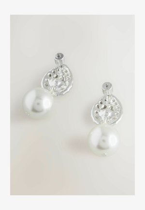 Silver earrings featuring a textured, petal-shaped accent above a large, luminous white pearl. Unique detailing within the silver.