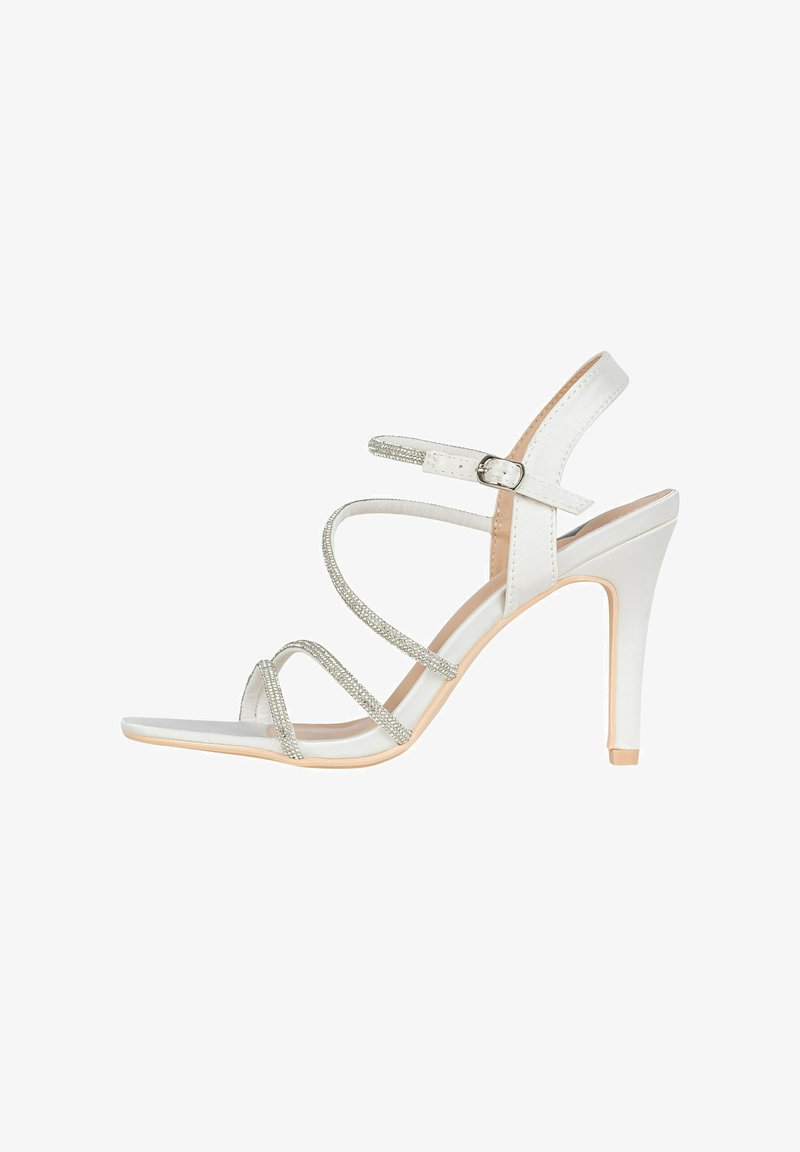 White high-heeled sandal with silver glitter straps, open toe design, and adjustable ankle buckle. Smooth texture and sleek silhouette.