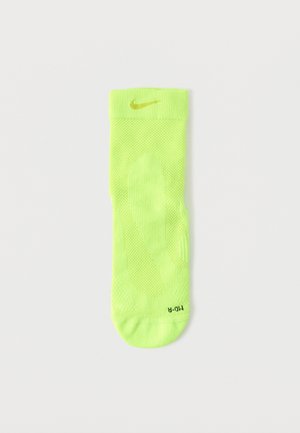 Neongrüner Nike-Socke mit geripptem Bündchen, strukturiertem Körper und Logo in Gold. Verfügt über belüftete Bereiche und eine gepolsterte Spitze.