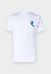 Hvid bomulds T-shirt med et blåt monsterhåndgrafik på venstre bryst. Enkel crew neck-designet med korte ærmer.