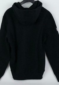 Black hoodie with a soft texture, kangaroo pocket, drawstring hood, and ribbed cuffs and hem. No visible logos or patterns.