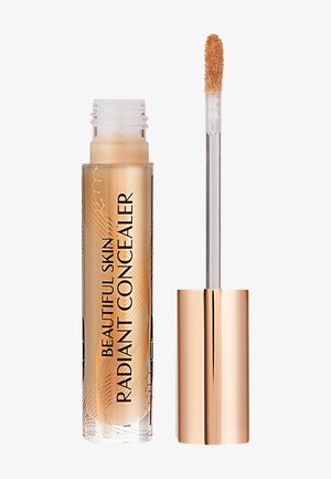 Radiant concealer in a clear tube with a gold cap. Features a tapered applicator wand. Product displays bold black text on the side.