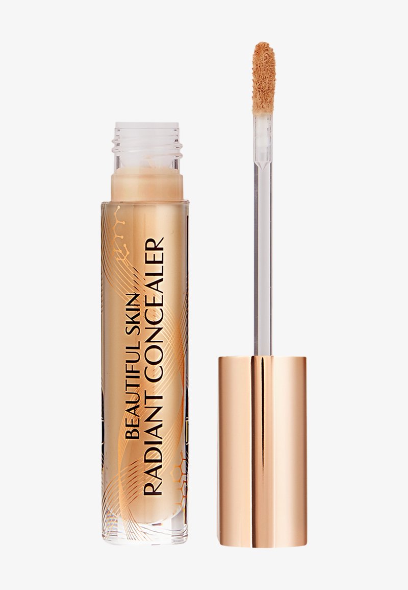 Radiant concealer in a clear tube with a gold cap. Features a tapered applicator wand. Product displays bold black text on the side.