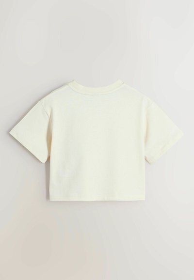 T-shirt court uni blanc cassé à manches courtes avec col rond, présenté à plat sur un fond clair, montrant le côté dos.
