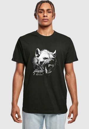 Black cotton T-shirt featuring a detailed graphic of a hyena's face, showcasing sharp teeth and fur texture with bold lettering beneath.