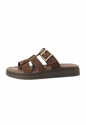 Καφέ δερμάτινο σανδάλι με σταυρωτούς ιμάντες, μεταλλική αγκράφα, επενδυμένο πάτο και υφασμένη καουτσούκ σόλα. Κλασικός σχεδιασμός και ουδέτερο χρώμα.