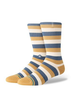 Striped socks in blue, yellow, and cream. Ribbed texture. Features a logo near the ankle and solid toe section. Standard sock height.