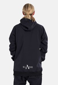 Black hooded jacket with a relaxed fit, featuring a logo at the lower back and elastic cuffs. Made from smooth, durable material.