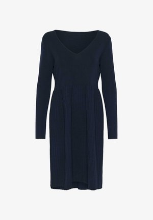 Marinblå stickad klänning med V-ringning, långa ärmar och en plisserad kjol. Slät textur, når till mitten av vaden med en figurnära överdel.