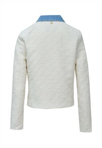 White textured long-sleeve jacket with blue collar and small gold button detail at upper center back, shown from behind.