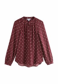 Blusa burdeos de manga larga con lunares blancos, cuello redondo, detalle plisado y puño elástico. Tejido suave y ligero con un dobladillo ligeramente curvado.
