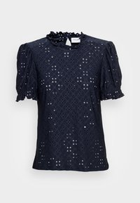 Marinblå topp med puffärmar, volangnedkant och ögla-mönster. Tillverkad av lätt stoff, med diamantformade utskärningar överallt.