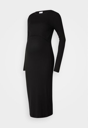 Robe de maternité noire à rayures avec des manches longues, un col rond et un corsage ajusté. Se drape sur le ventre et se termine sous le genou.