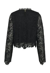 Top corto in pizzo nero con maniche lunghe, caratterizzato da motivi floreali, bordi a scallop e chiusura sul retro con un piccolo dettaglio a chiave.