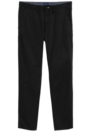 Mustat puuvillachinot, joissa on sileä etuosa, kaksi sivutaskua ja klassinen istuvuus. Viimeistelty nappisuljennalla ja hienovaraisella vyötärökoristeella.