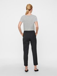 Gray fitted t-shirt and dark tapered trousers made from soft fabric. Trousers feature a relaxed waistband and rolled cuffs; simple design.