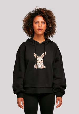 Black hooded sweatshirt featuring a frontal graphic of a colorful cartoon rabbit. The fabric appears soft, with a relaxed fit and cuffed sleeves.