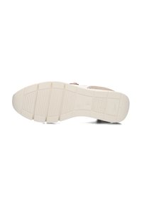 Sneaker zool in lichtbeige rubber met een gestructureerd patroon, voorzien van verhoogde secties en een gladde afwerking. Stevig en flexibel ontwerp.