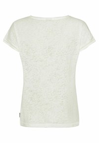 T-shirt beige clair avec un motif texturé, manches courtes et encolure ronde. Présente des surpiqûres décoratives aux bords des manches.