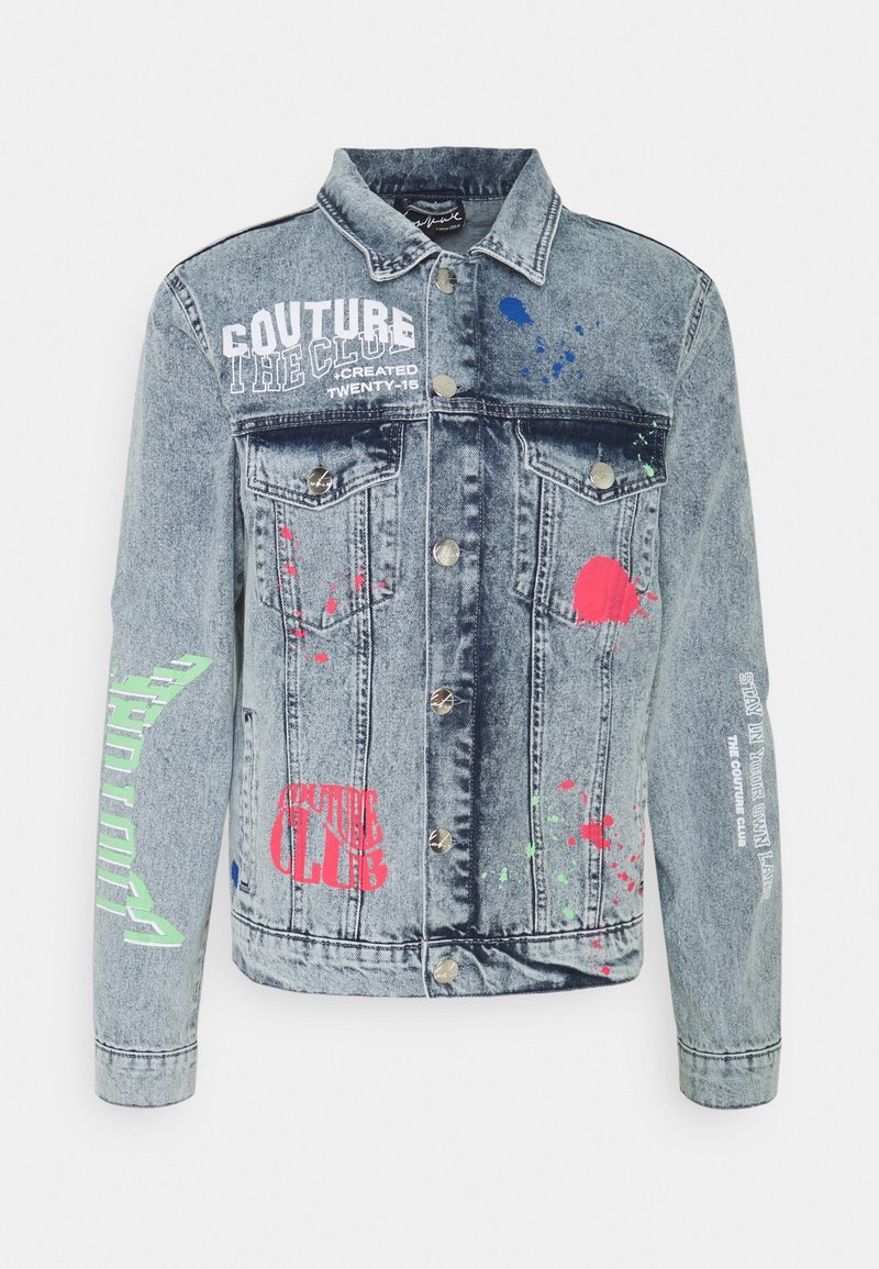 Denim jacket with a faded blue wash, featuring graphic prints in red, green, and blue. Button closures and two front pockets.