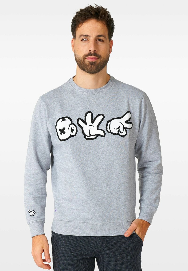 Sudadera gris con un atrevido gráfico negro de un cráneo y gestos de mano en el frente. Puños y dobladillo acanalados. Material de felpa suave.