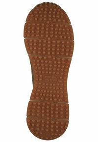Rubber shoe sole in tan color with textured grip, circular patterns, and horizontal grooves. Features brand logo and size indicator.