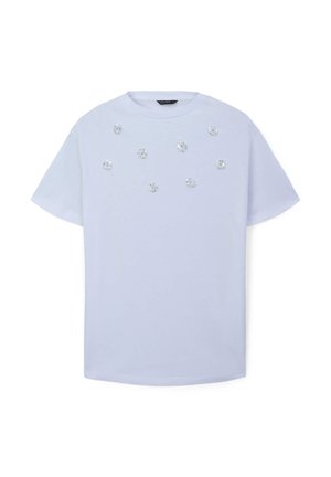 T-shirt en coton bleu clair avec des manches courtes, orné d'embellissements en forme de fleurs dispersés sur le devant. Encolure ronde.