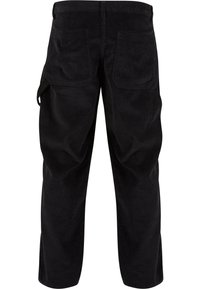 Pantalon en velours côtelé noir avec deux poches plaquées à l'arrière et une boucle latérale sur la jambe gauche, vu de dos.