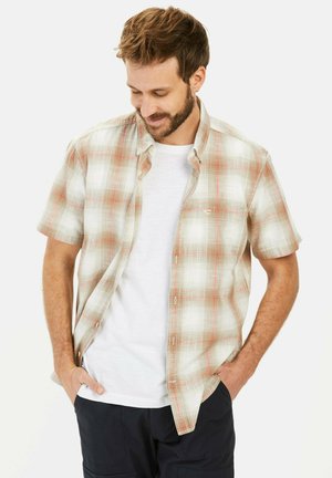 Short-sleeve, plaid shirt in beige and light red, made of lightweight fabric. Features button-down collar and chest pocket, layered over a white tee.