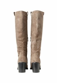 Knee-high boots in soft beige suede with a smooth texture, featuring a block heel and horizontal stitching detail on the back.