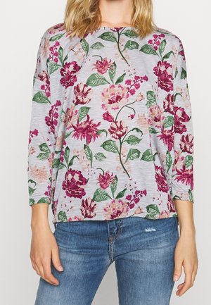 Top a maniche lunghe floreale con sfondo grigio chiaro, fiori vivaci in rosa e verde, e una vestibilità rilassata con polsini a costine.