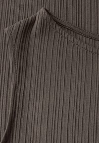 Dark brown ribbed fabric with a soft texture, featuring a rounded neckline and short sleeves, showcasing vertical lines in the material.