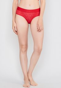 Red lace underwear with a wave pattern, featuring a wide elastic waistband embossed with "JOOP! JEANS." Lightweight and form-fitting design.