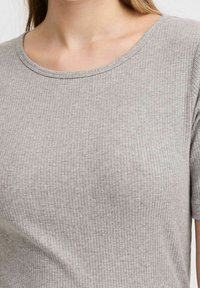 Grå ribbet kortærmet top med rund halsudskæring, lavet af blødt, tekstureret stof med diskrete syningsdetaljer.