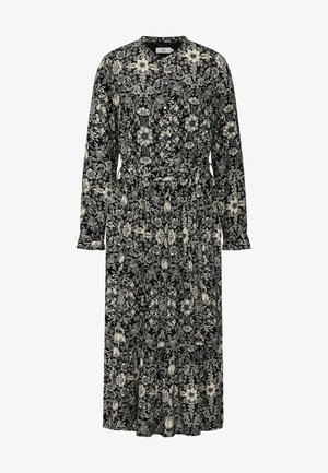 Black floral long-sleeve dress featuring a v-neckline, cinched waist, and tiered skirt with white floral and leaf patterns.