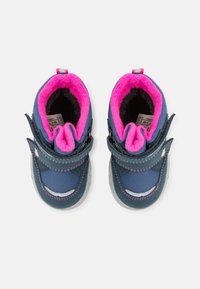 Zapatos azules con forro de piel sintética rosa, tira de velcro, material exterior texturizado, suelas de goma y acentos blancos en la punta.