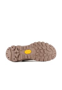 Semelle en caoutchouc marron avec un motif de traction texturé et un logo Vibram jaune au centre. Convient pour une meilleure adhérence sur diverses surfaces.