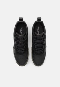 Black athletic shoes with a smooth leather upper, textured accents, and cushioned soles. Features round laces and pull tabs for easy wear.