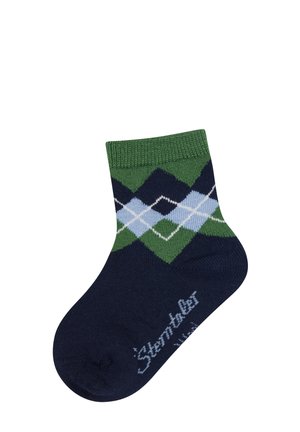 Dunkelblaue Socke mit grünem, hellblauem und weißem Argyle-Muster und grünem Bündchen, mit dem Text "Sterntaler" nahe der Zehe.