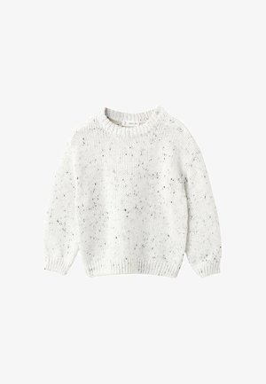 Pull en tricot blanc avec un col rond, arborant un motif texturé et de petites taches noires, accentué par des boutons sur une épaule.
