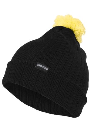 Must kollane kudumüts, millel on peal kollane pom-pom ja küljes on logotagi. Tekstuur on ribakujuline ja veniv.
