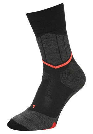 Calcetín negro y gris oscuro con un puño acanalado, que presenta acentos rojos, secciones texturizadas y el número "7" en el lateral.