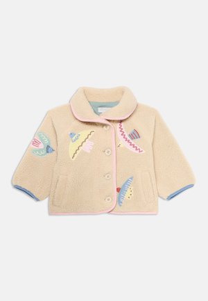 Beež fliiskangas jakk, millel on krae, roosa ääris ja värvilised tikandid, sealhulgas erinevad kujundid ja mustrid.