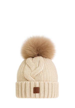 Beige knitted winter hat with a large fluffy pom-pom on top and a folded brim featuring a small brown decorative patch.