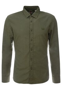 Olijfgroene overhemd van katoen met knopen. Heeft lange mouwen, een kraag en een klein logoplaatje op de borst.